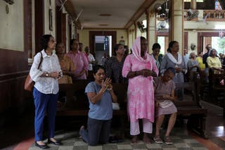 People attend a memorial held for the deceased crew members